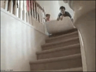 kid falls during matress slide on the stairs