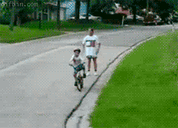 dad teaching his kid to bike