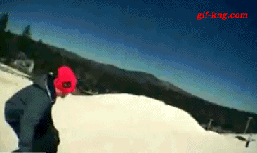 Guy switches snowboards after jump