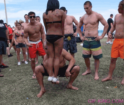 Muscle Man Lift a Girl on Beach