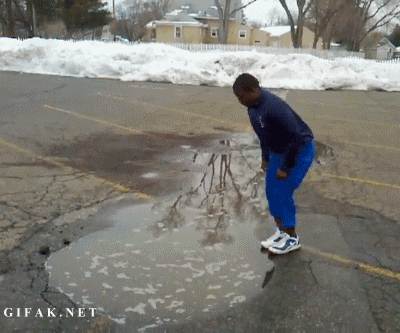 Kid Jumps Into Deep Puddle