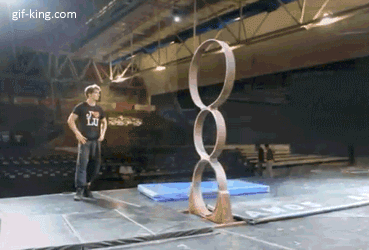 amazing dude back flipping through rings