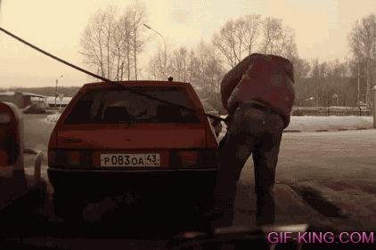 Russian Guy Lifts Car at Gas Station