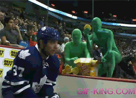 Green Men Throw Waffles at Hockey Player