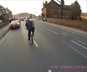 taking off his jacket while riding a bike
