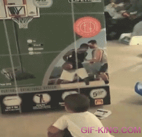 Confused Boy Trying To Shoot A Basketball Into A Hoop
